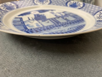 A Chinese blue and white dish with figures in an interior, Kangxi mark and of the period